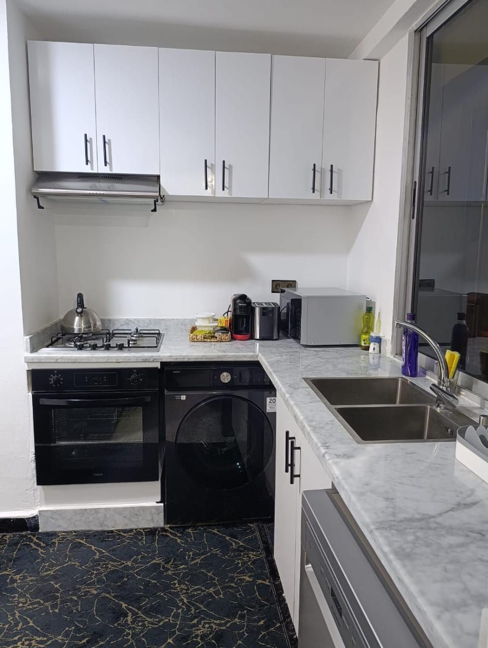 Kitchen or kitchenette, dishwasher, oven, stove, toaster, washing machine, dryer