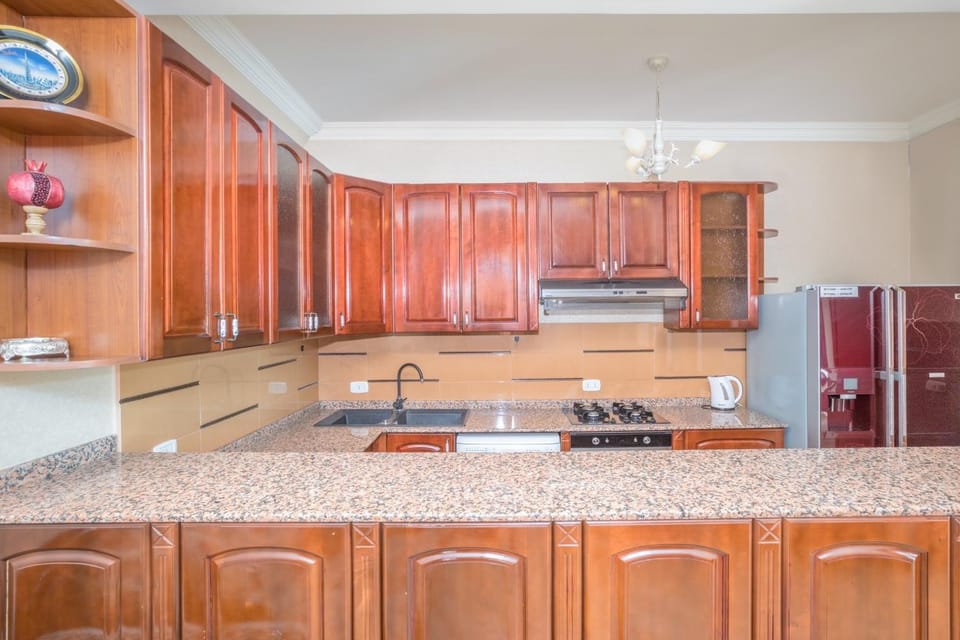 Kitchen or kitchenette, dishwasher, oven, stove