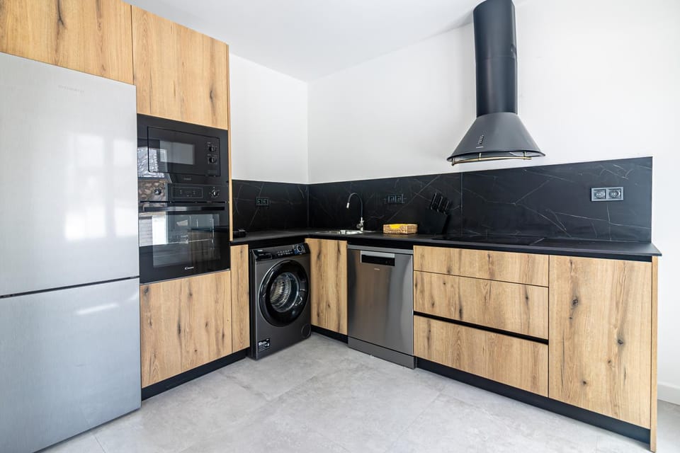 Kitchen or kitchenette, dishwasher, oven, stove, washing machine