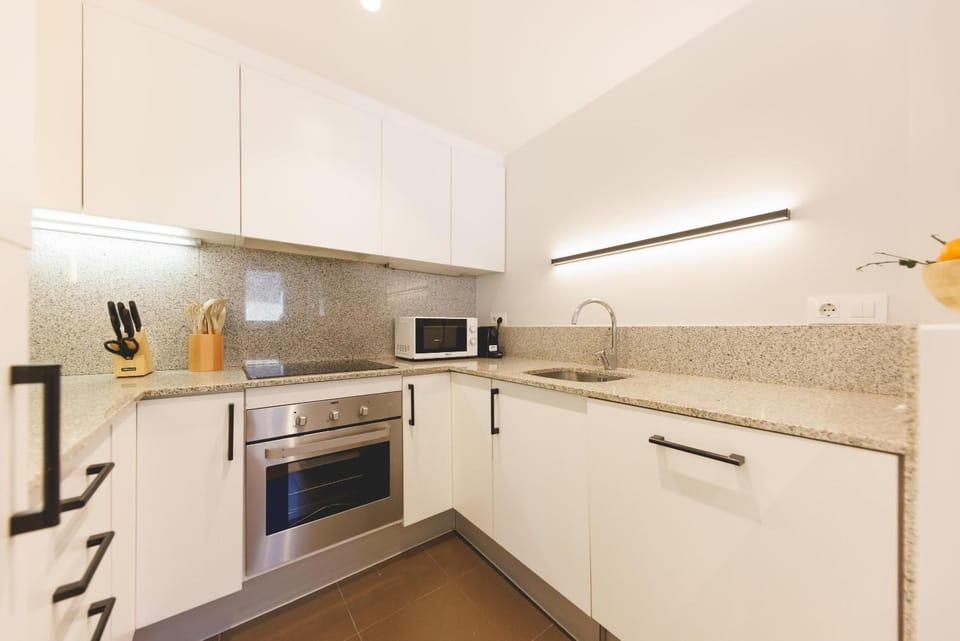 Kitchen or kitchenette, dishwasher, oven, stove