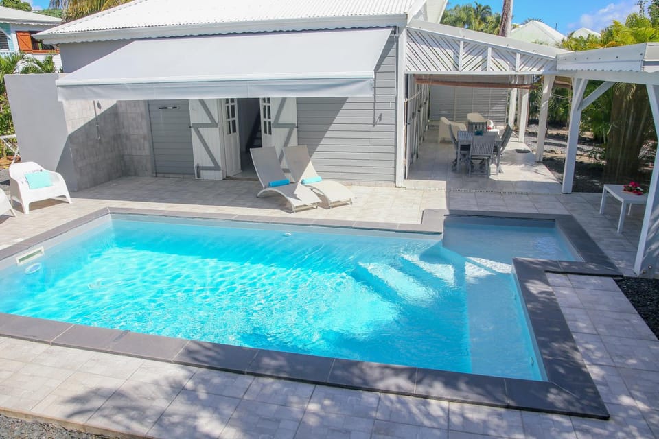 Property building, Patio, Pool view, Swimming pool, sunbed