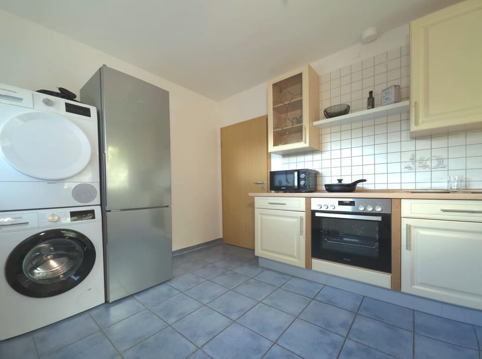 Kitchen or kitchenette, dishwasher, oven, stove, toaster, washing machine, dryer