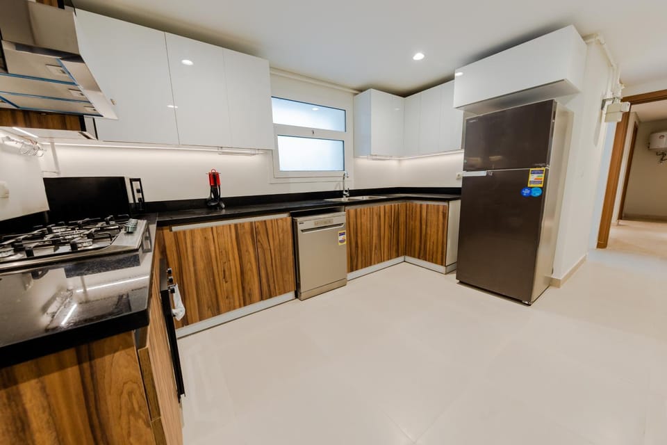 Kitchen or kitchenette, dishwasher, microwave, oven, stove