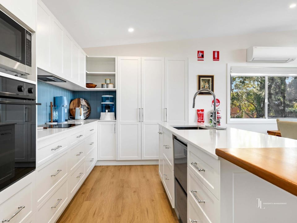 Kitchen or kitchenette, dishwasher, oven, stove