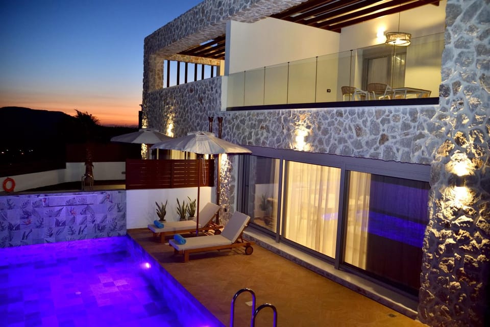Property building, Patio, Night, View (from property/room), Balcony/Terrace, Mountain view, Pool view, Swimming pool, sunbed