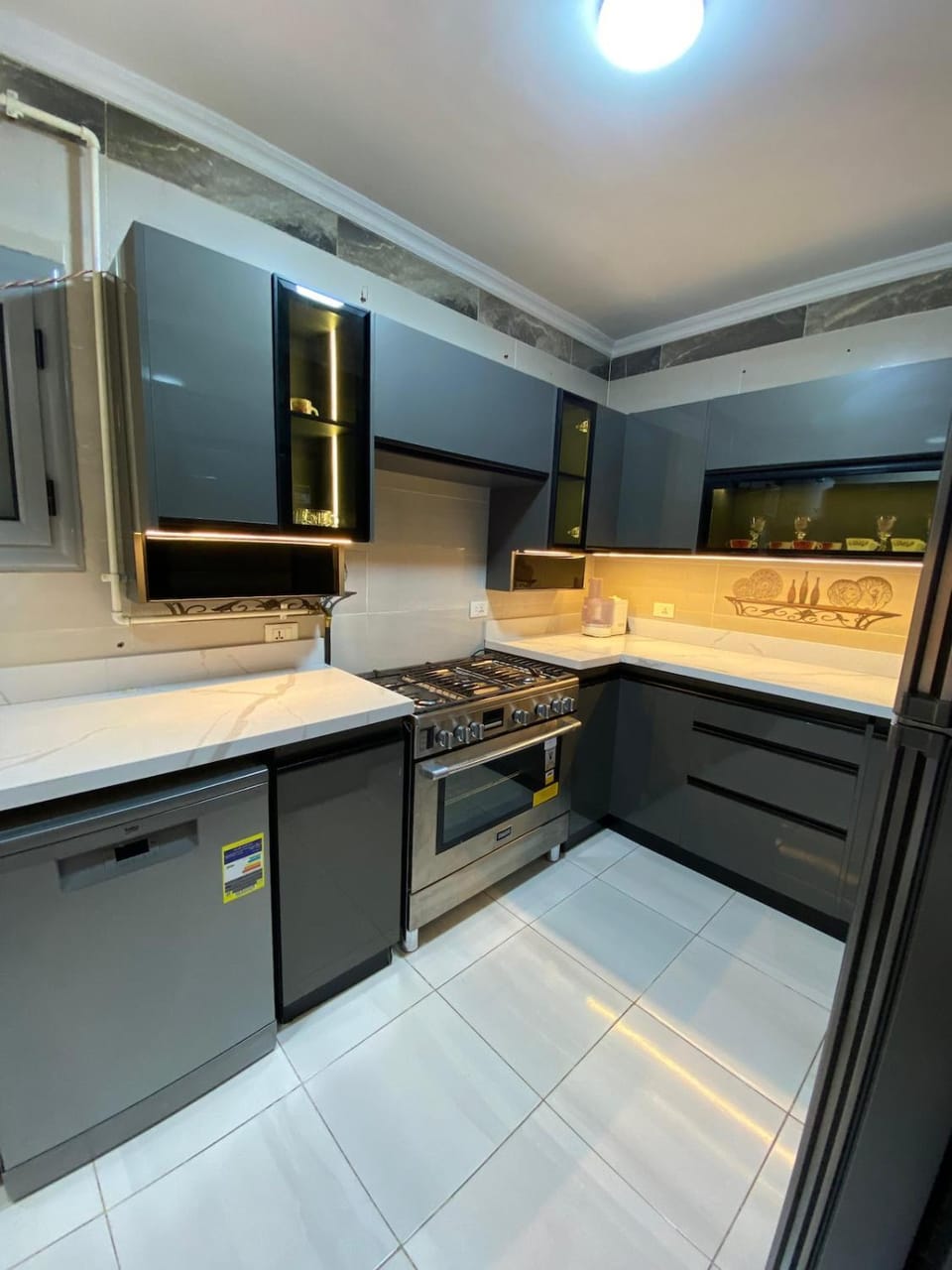 Kitchen or kitchenette, dishwasher, oven, stove