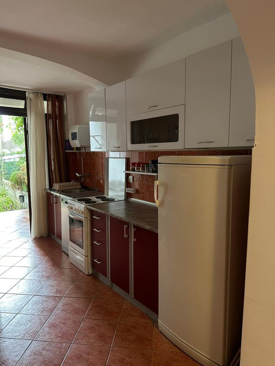 Kitchen or kitchenette, dishwasher, oven, stove