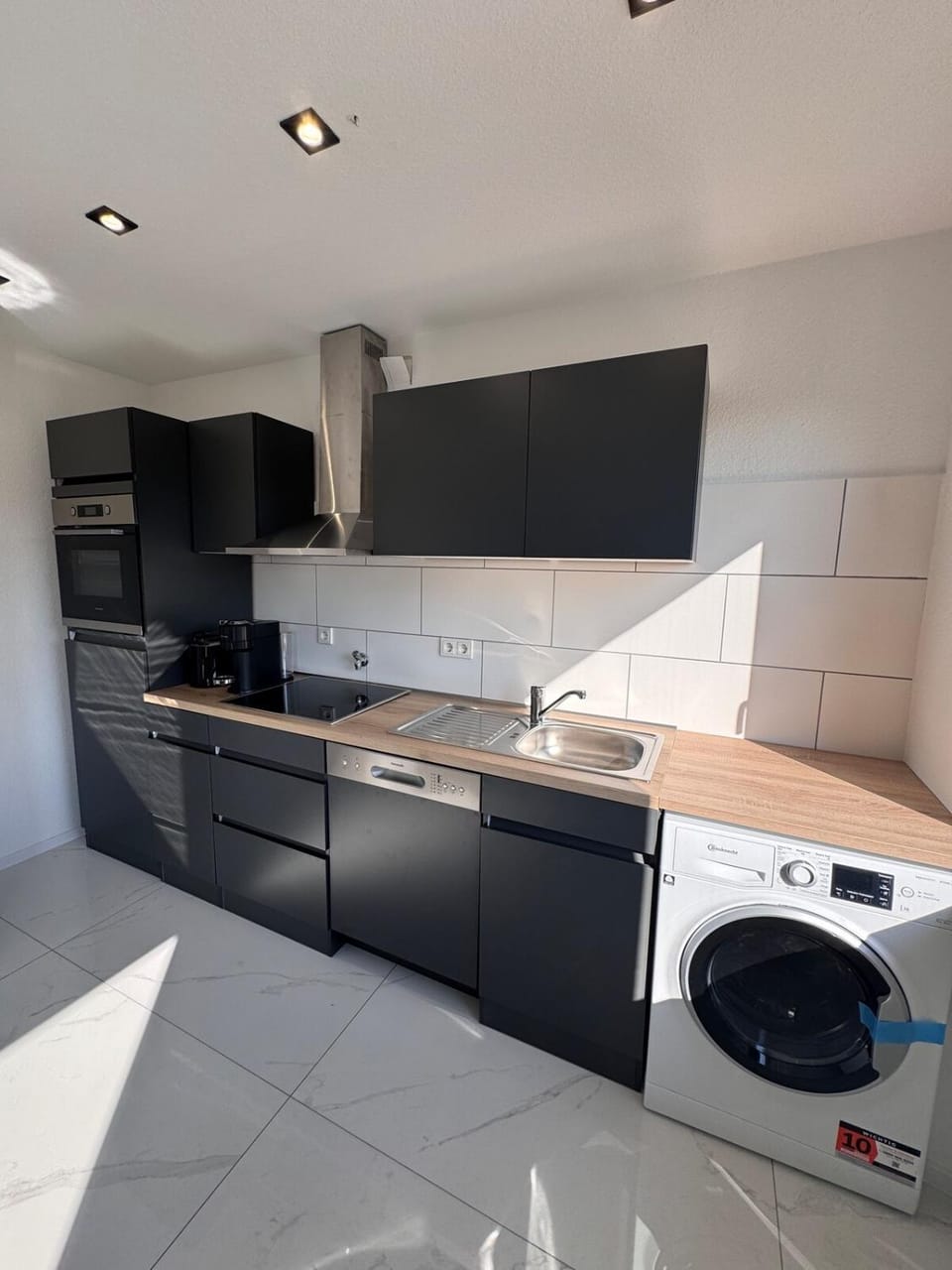 Kitchen or kitchenette, dishwasher, stove, washing machine, dryer