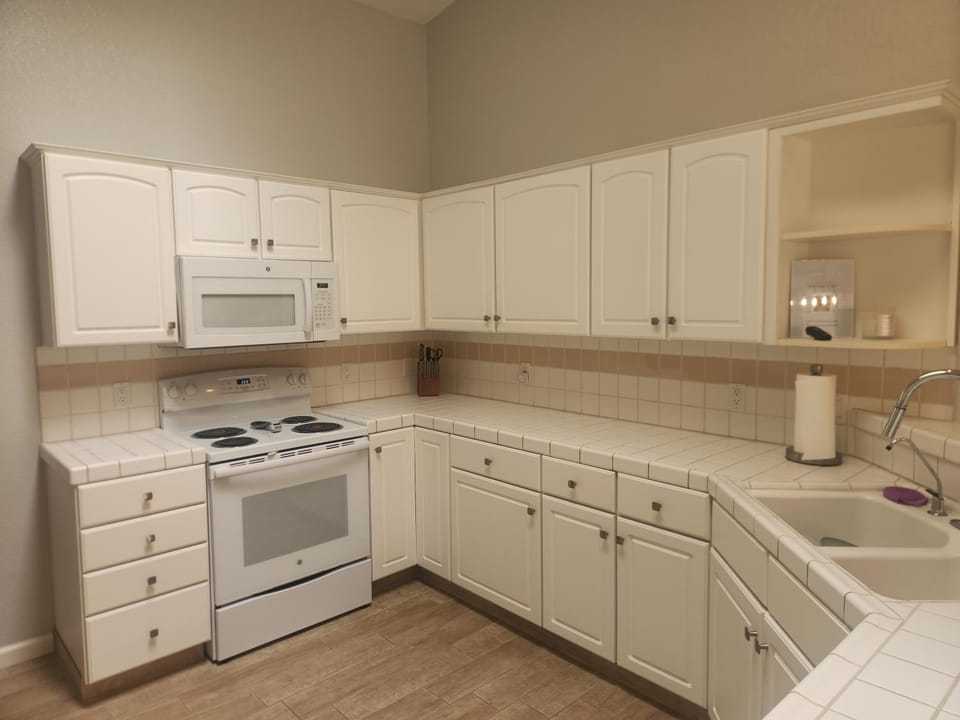 Kitchen or kitchenette, dishwasher, microwave, oven, stove