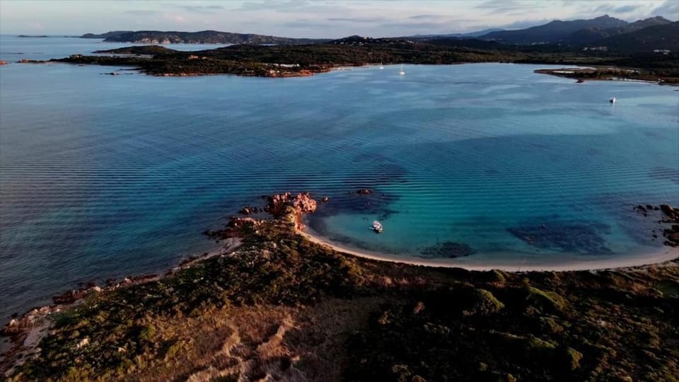 Wild Escape Island Bay Experience Docked boat in Sardinia