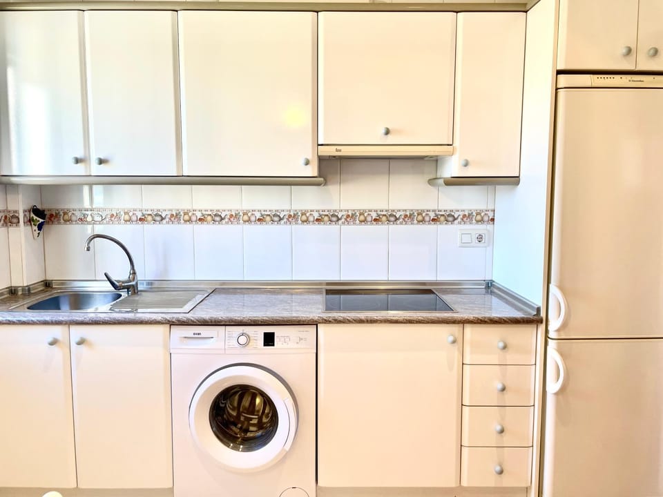 Kitchen or kitchenette, stove, washing machine