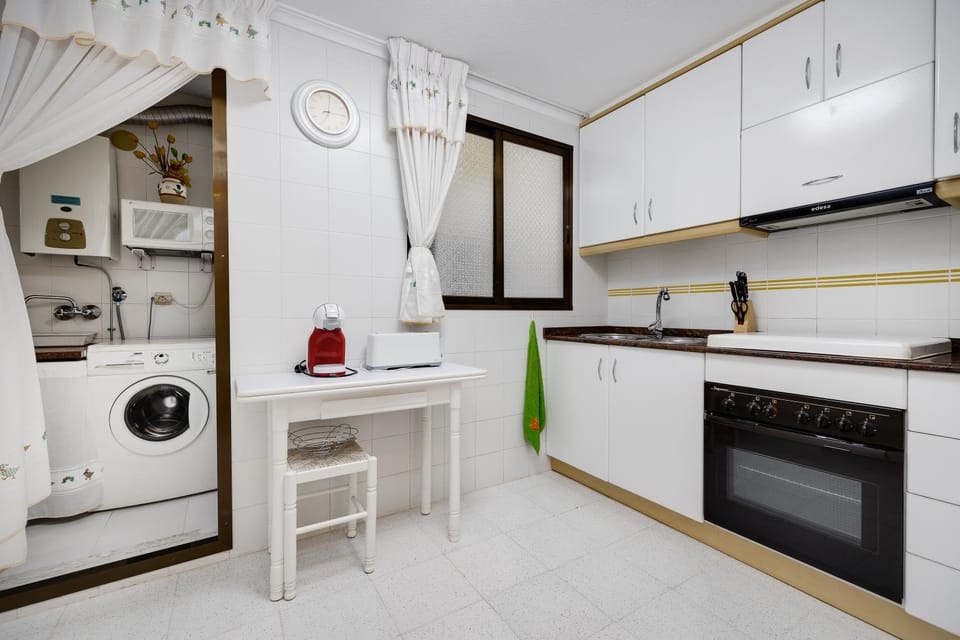 Kitchen or kitchenette, oven, stove, toaster, washing machine
