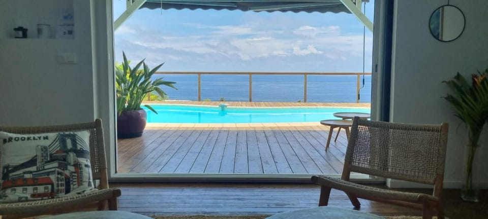 Living room, Seating area, Pool view, Sea view, Swimming pool