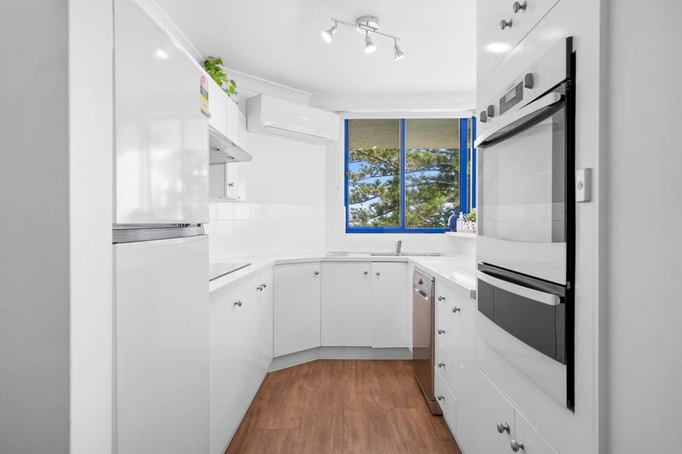 Kitchen or kitchenette, dishwasher, oven, stove