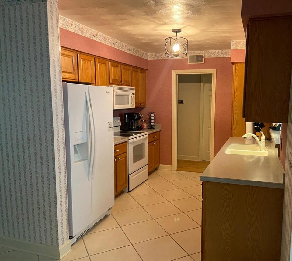 Kitchen or kitchenette, dishwasher, microwave, oven, stove