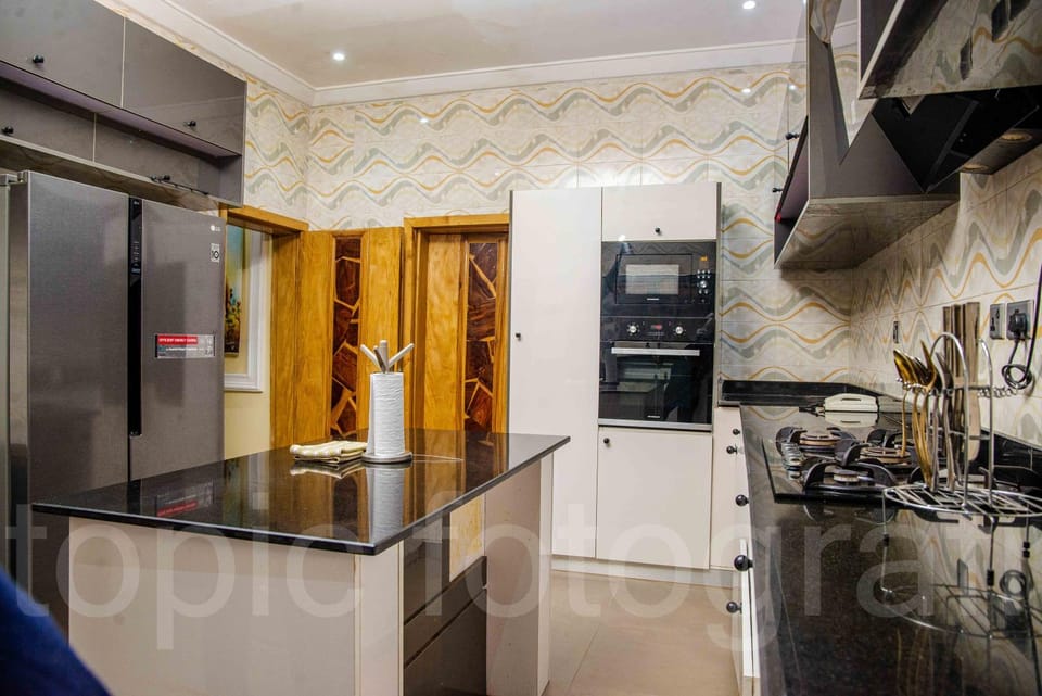 Kitchen or kitchenette, dishwasher, oven, stove