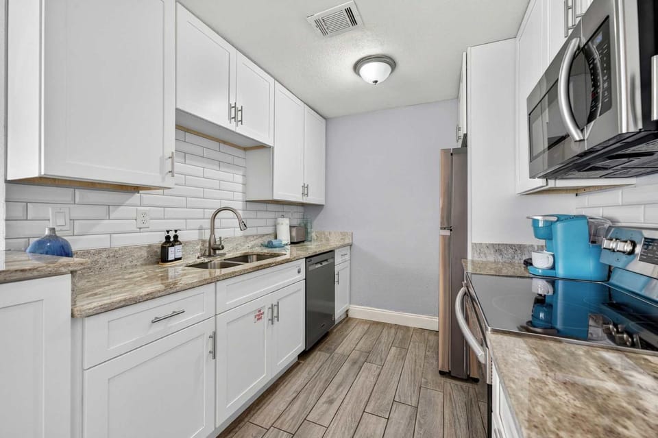 Kitchen or kitchenette, dishwasher, oven, stove, toaster