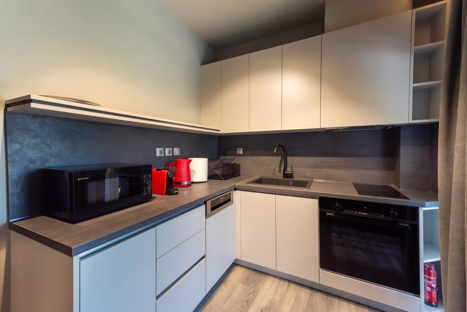 Kitchen or kitchenette, dishwasher, locker, microwave, oven, stove