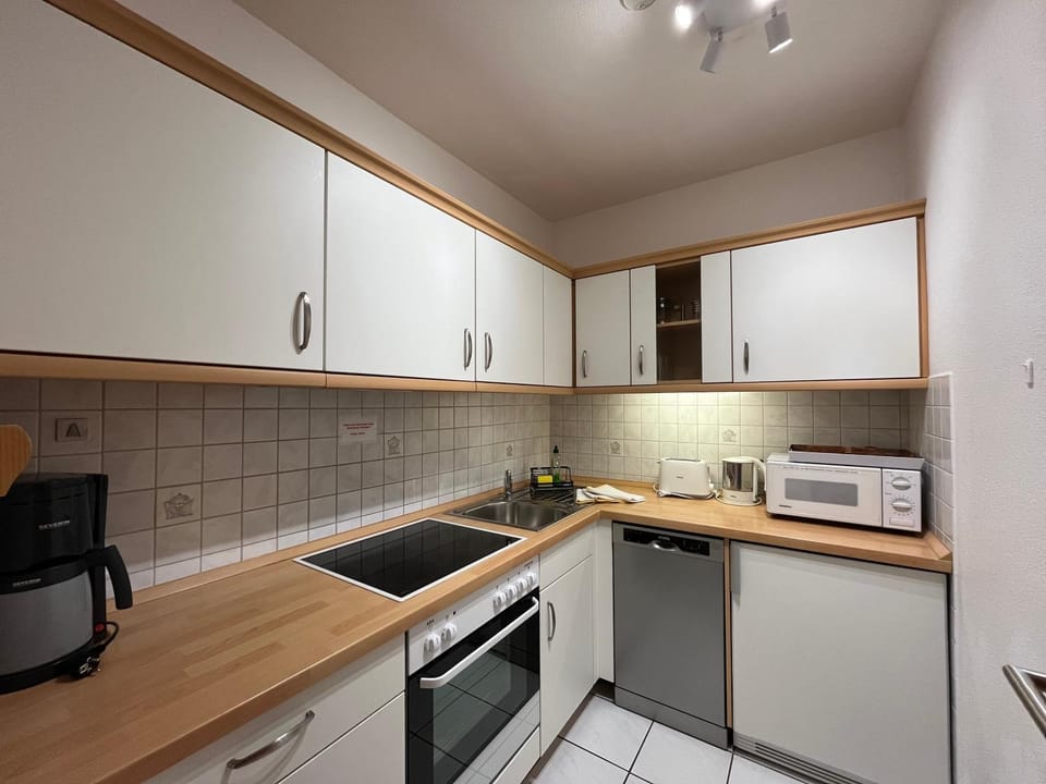 Kitchen or kitchenette, dishwasher, oven, stove, toaster