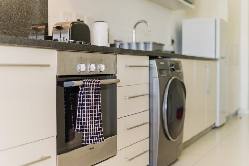 Kitchen or kitchenette, oven, stove, washing machine, dryer