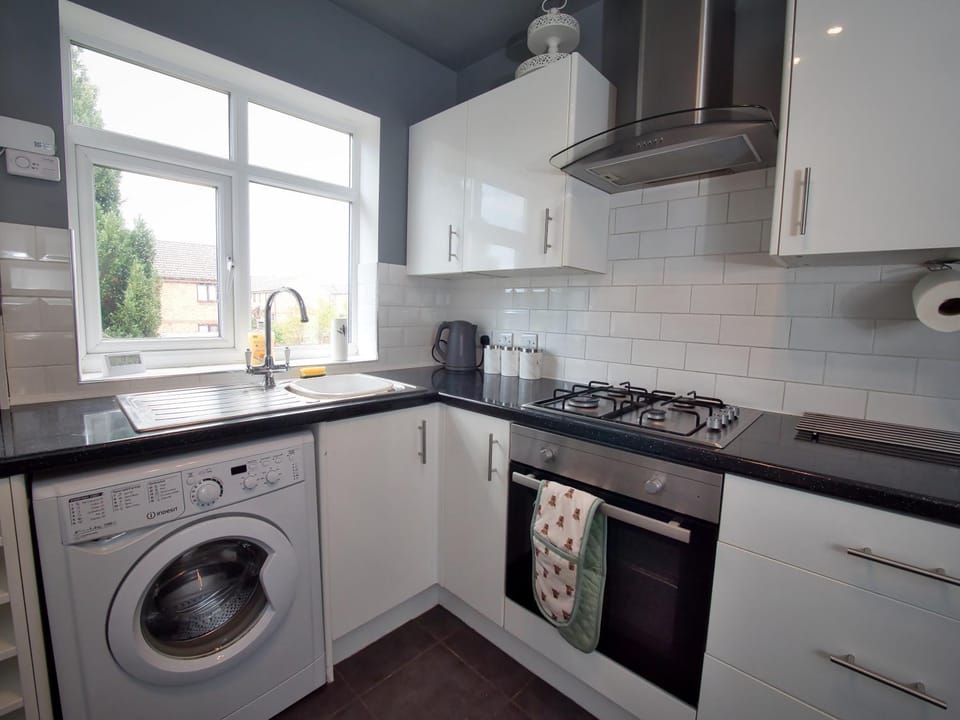 Kitchen or kitchenette, dishwasher, oven, stove, toaster, washing machine, dryer