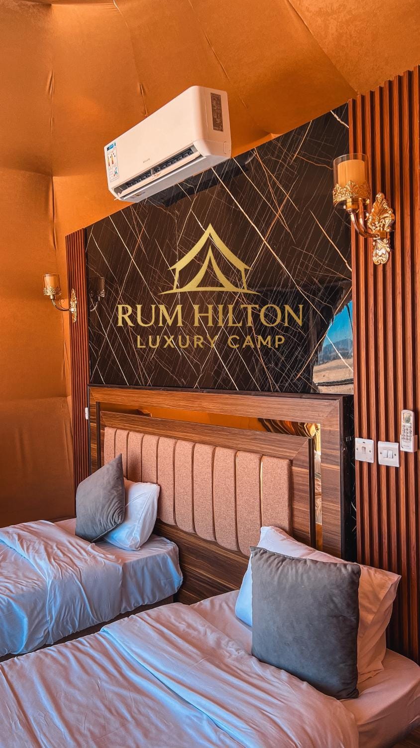 Property building, Bed, Property logo or sign, Living room, Photo of the whole room, Seating area, Logo/Certificate/Sign, Text overlay, Certificate/Award, air conditioner