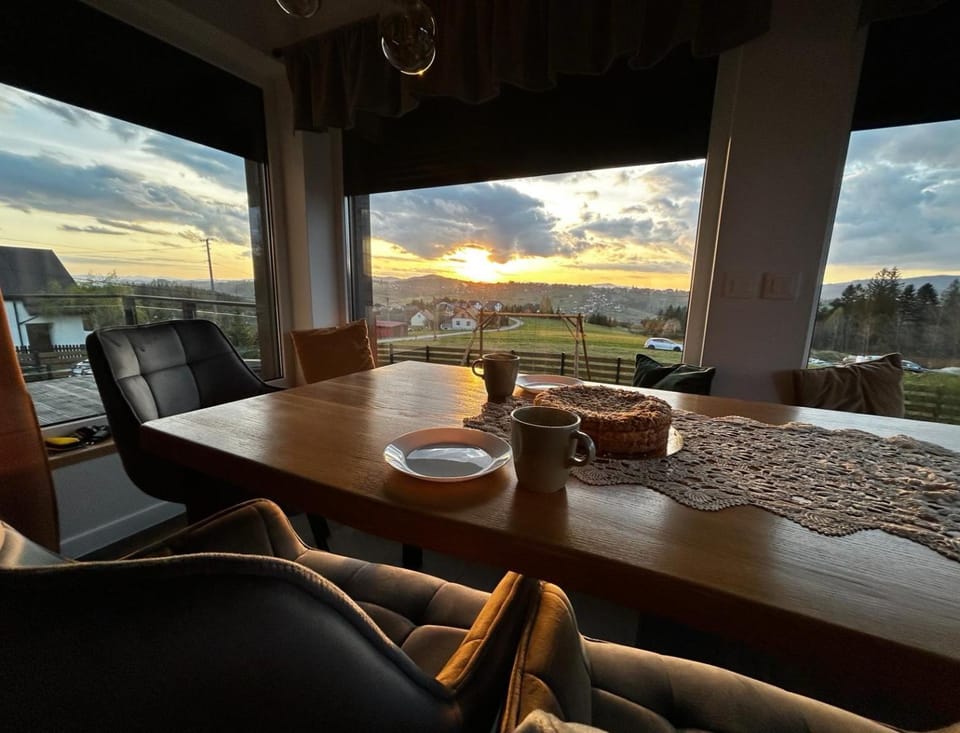 View (from property/room), Living room, Seating area, Dining area, Sunset