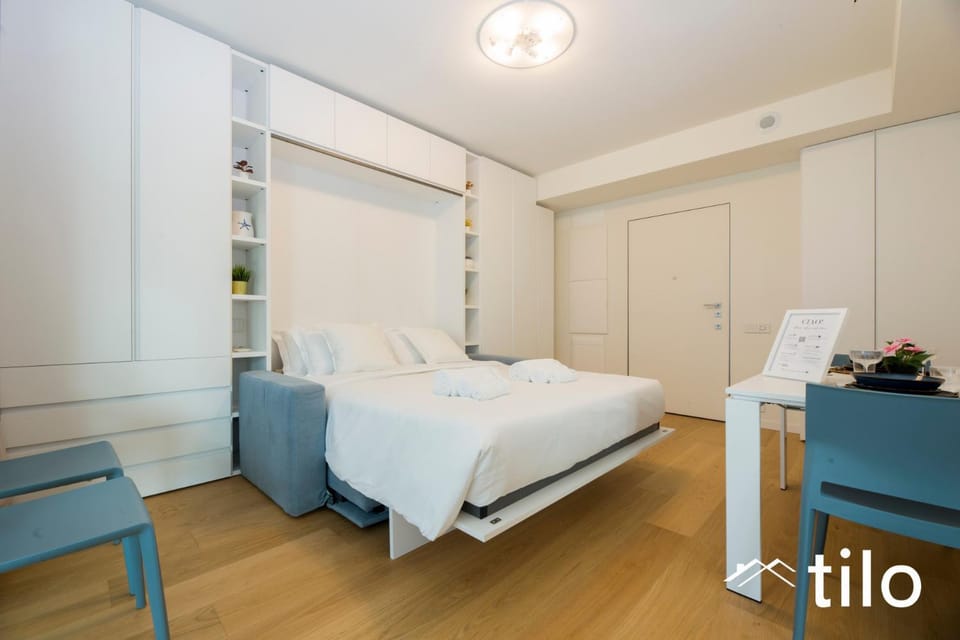 Bed, Photo of the whole room, Bedroom, Text overlay, hair dresser, towels