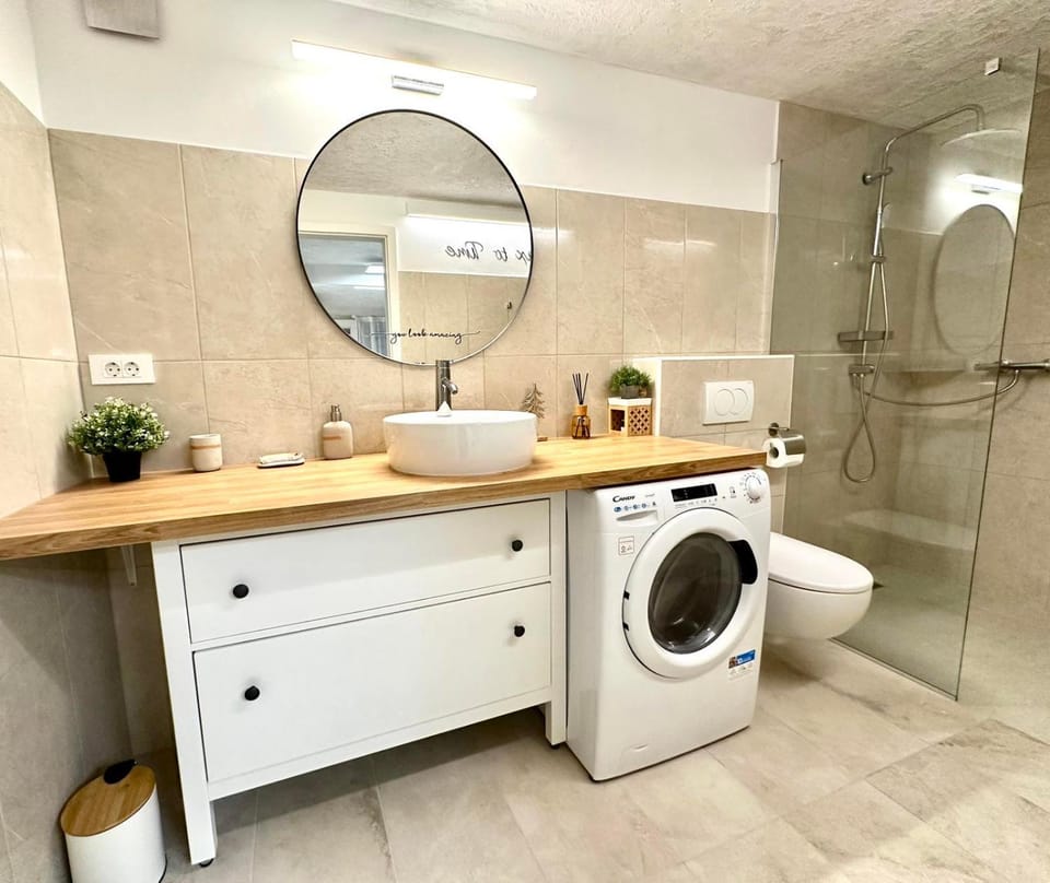 Shower, Toilet, towels, washing machine, dryer