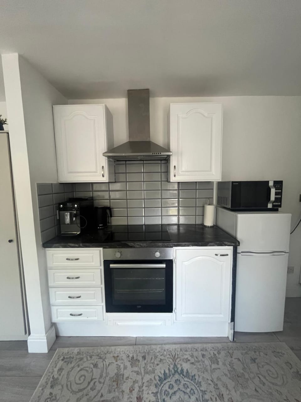 Kitchen or kitchenette, microwave, stove, toaster