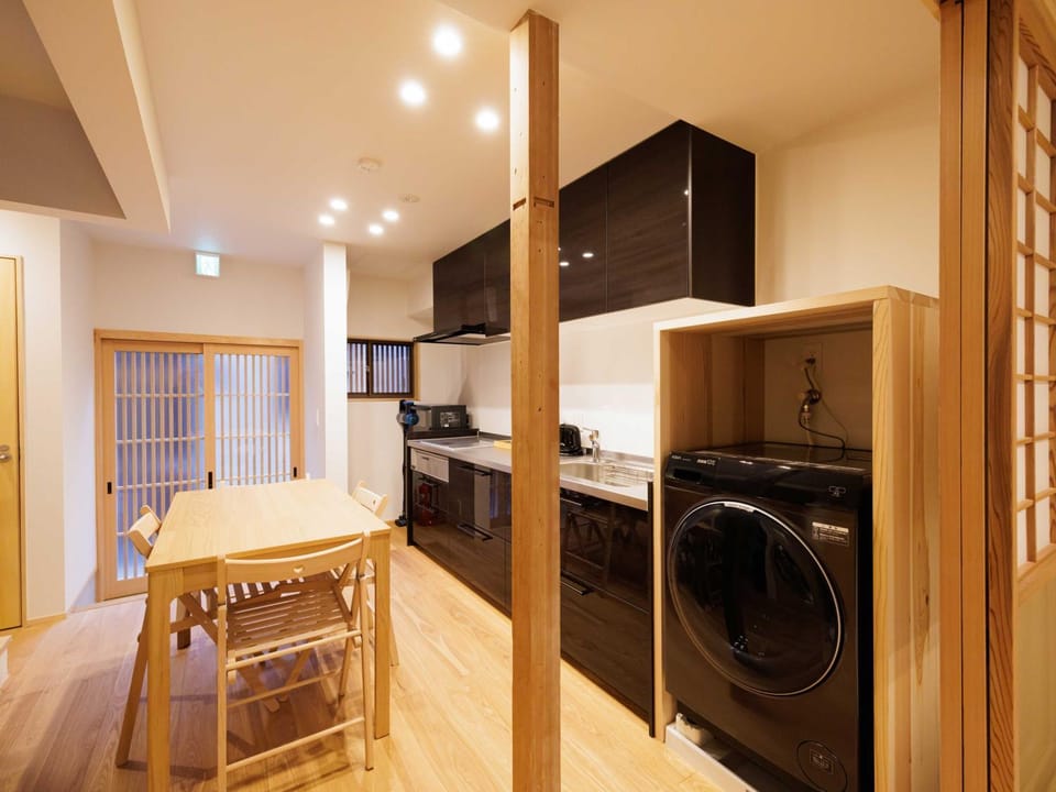 Kitchen or kitchenette, Photo of the whole room, Dining area, stove, washing machine, dryer