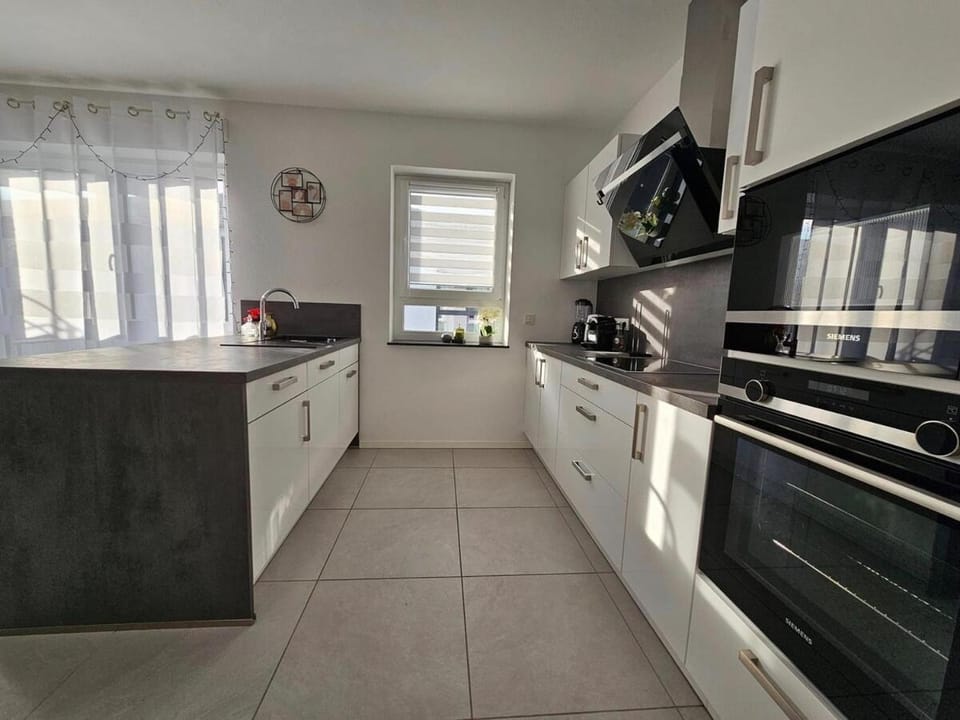 Kitchen or kitchenette, dishwasher, oven, stove