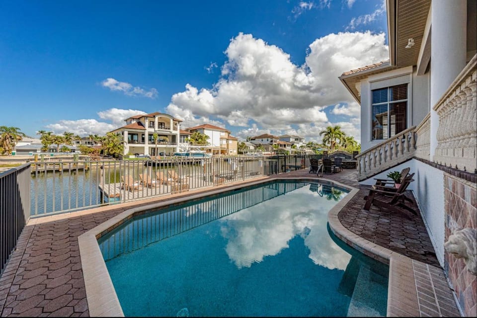 Waterfront Retreat! Breathtaking Water Views - Sparkling Pool & Dock - Walk to the Beach! House in Vanderbilt Beach