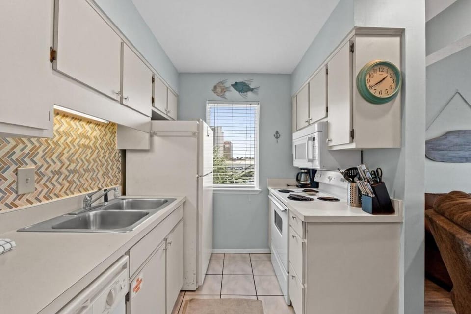 Kitchen or kitchenette, dishwasher, oven, stove