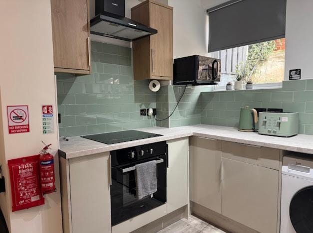 Kitchen or kitchenette, stove, toaster, washing machine, dryer