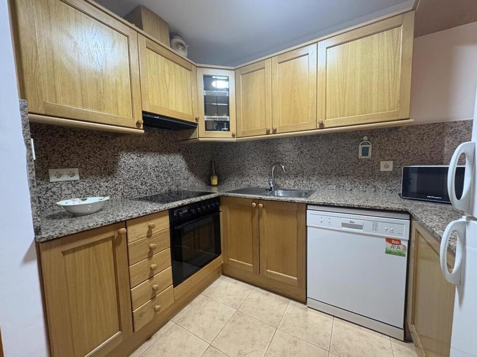 Kitchen or kitchenette, dishwasher, oven, stove