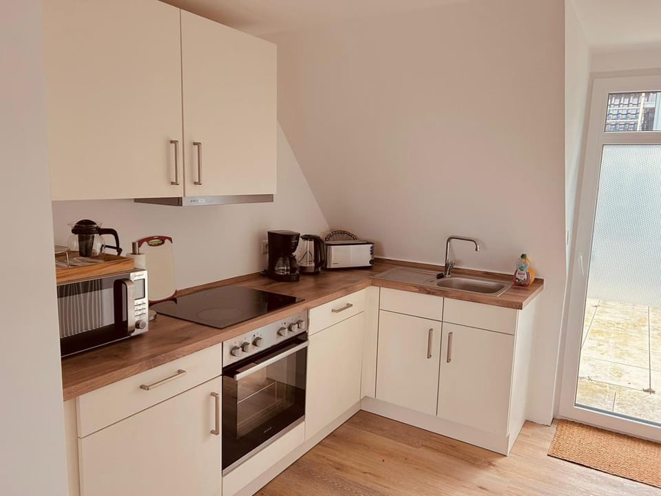 Kitchen or kitchenette, dishwasher, microwave, stove, toaster