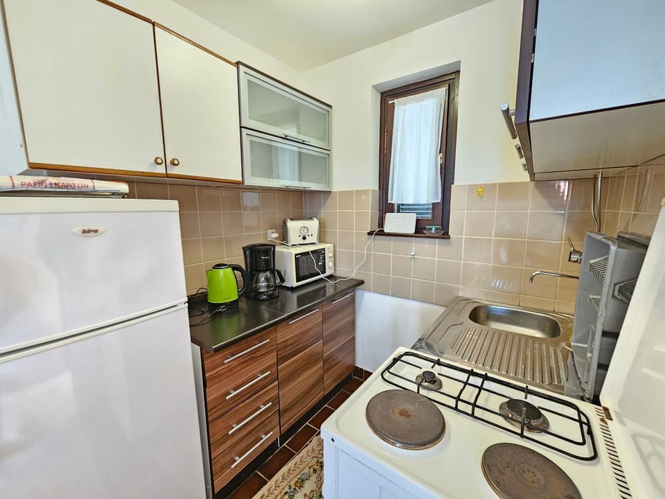 Kitchen or kitchenette, microwave, stove, toaster