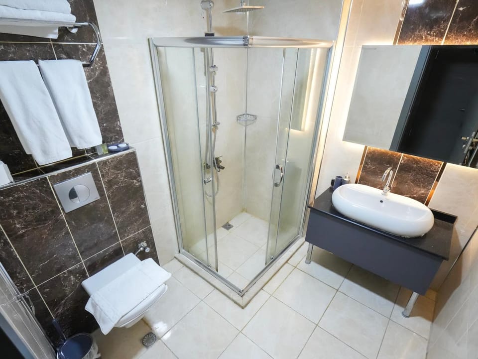 Shower, Toilet, Bathroom, hair dryier, towels