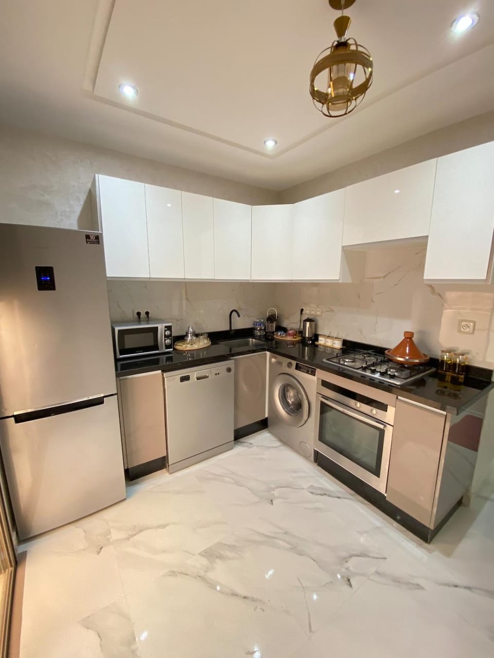 Kitchen or kitchenette, dishwasher, oven, stove