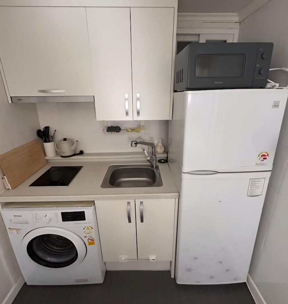 Kitchen or kitchenette, microwave, stove, washing machine