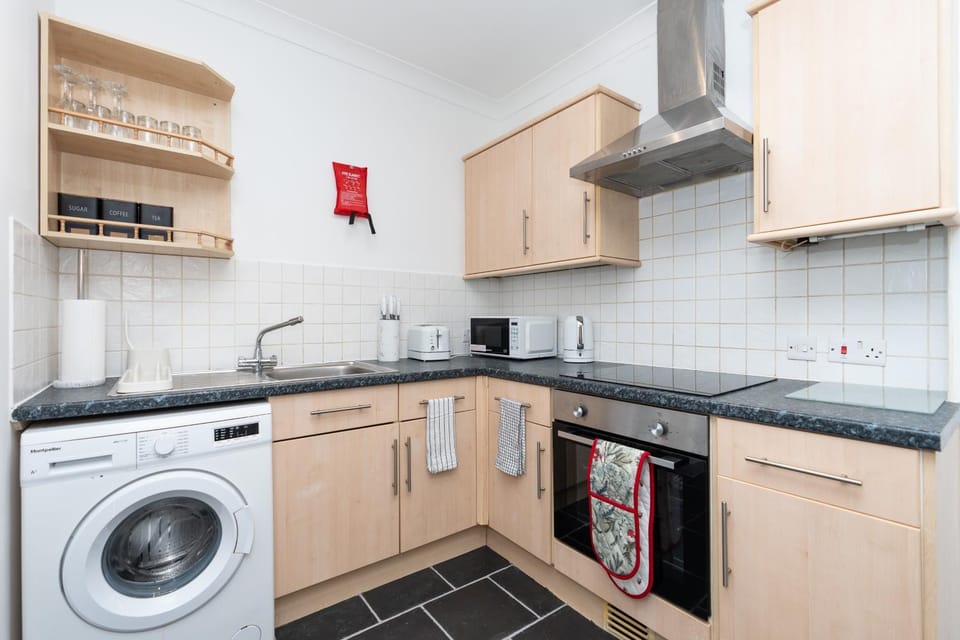 Kitchen or kitchenette, minibar, oven, stove, toaster, washing machine, dryer