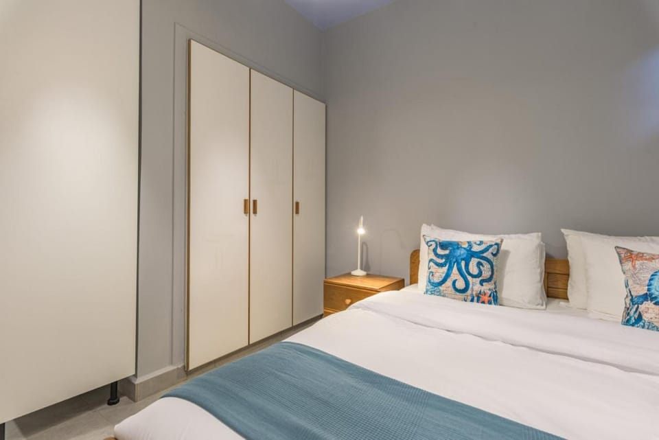 Bed, Bedroom, flat iron, hair dryier, towels, wardrobe