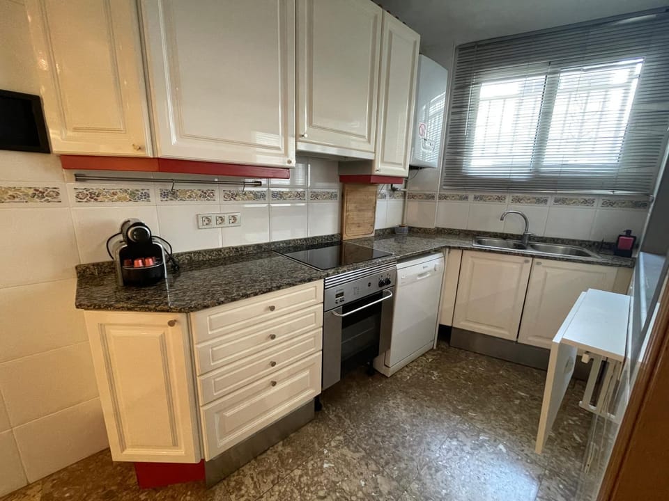 Kitchen or kitchenette, dishwasher, oven, stove