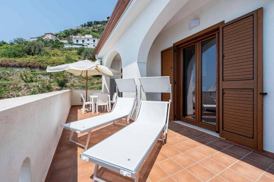Property building, Patio, Natural landscape, View (from property/room), Balcony/Terrace, Balcony/Terrace, Living room, Seating area, sunbed