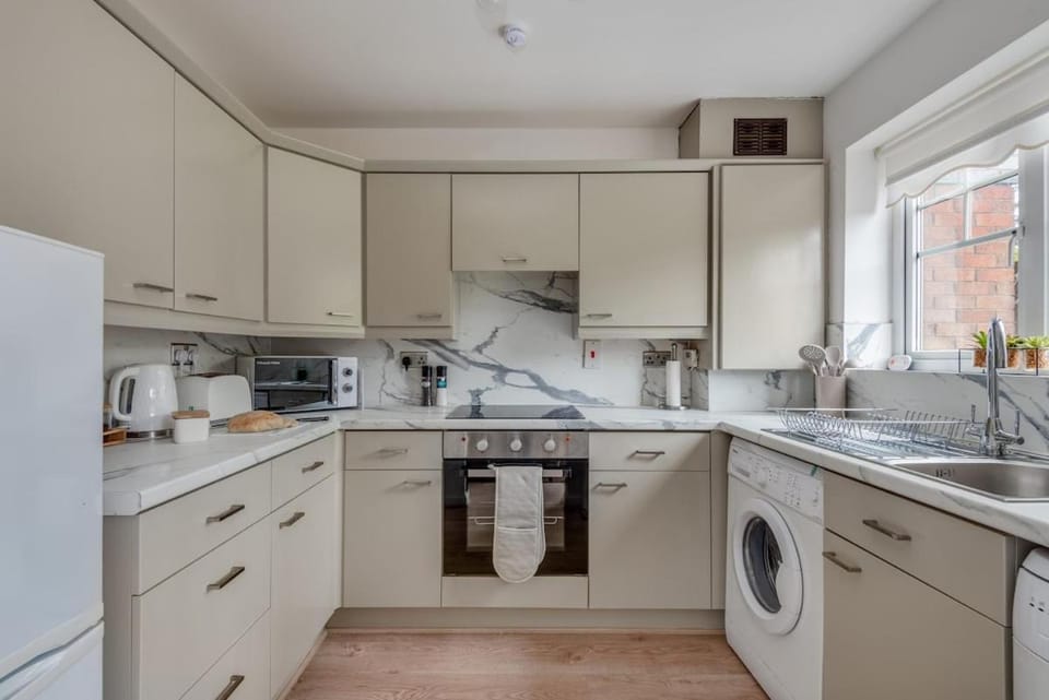 Kitchen or kitchenette, dishwasher, oven, stove, toaster, washing machine