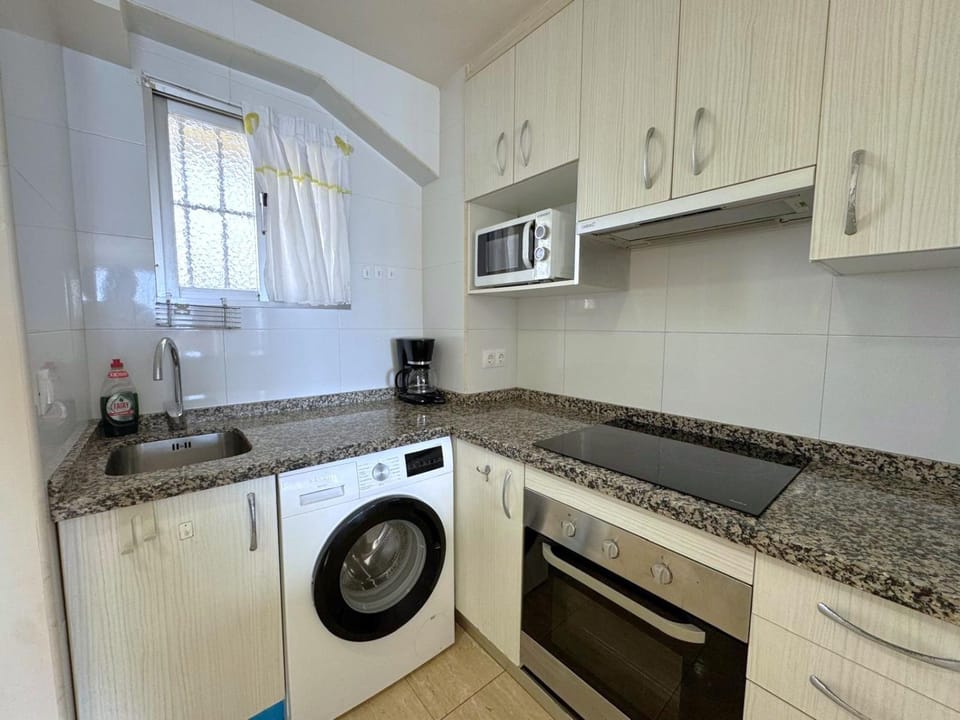 Kitchen or kitchenette, oven, stove, washing machine
