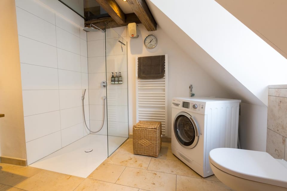 Shower, Toilet, Bathroom, Bath, hair dryier, towels, washing machine, washing machine, dryer