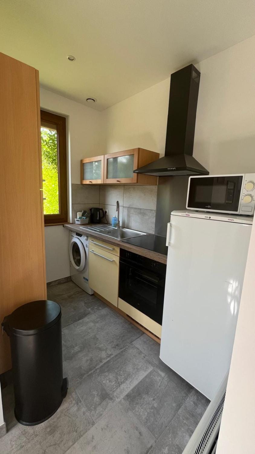 Kitchen or kitchenette, microwave, oven, stove, washing machine