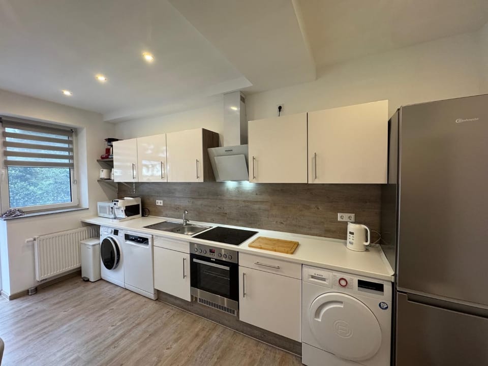 Kitchen or kitchenette, dishwasher, oven, stove, toaster, washing machine, dryer